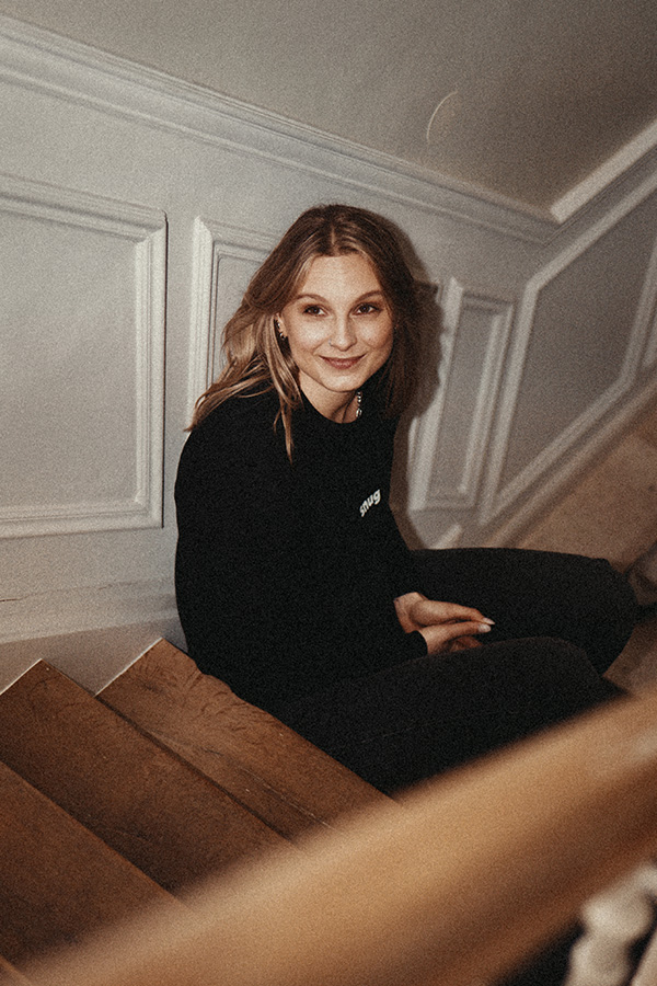 A team member in a snug shirt on a staircase
