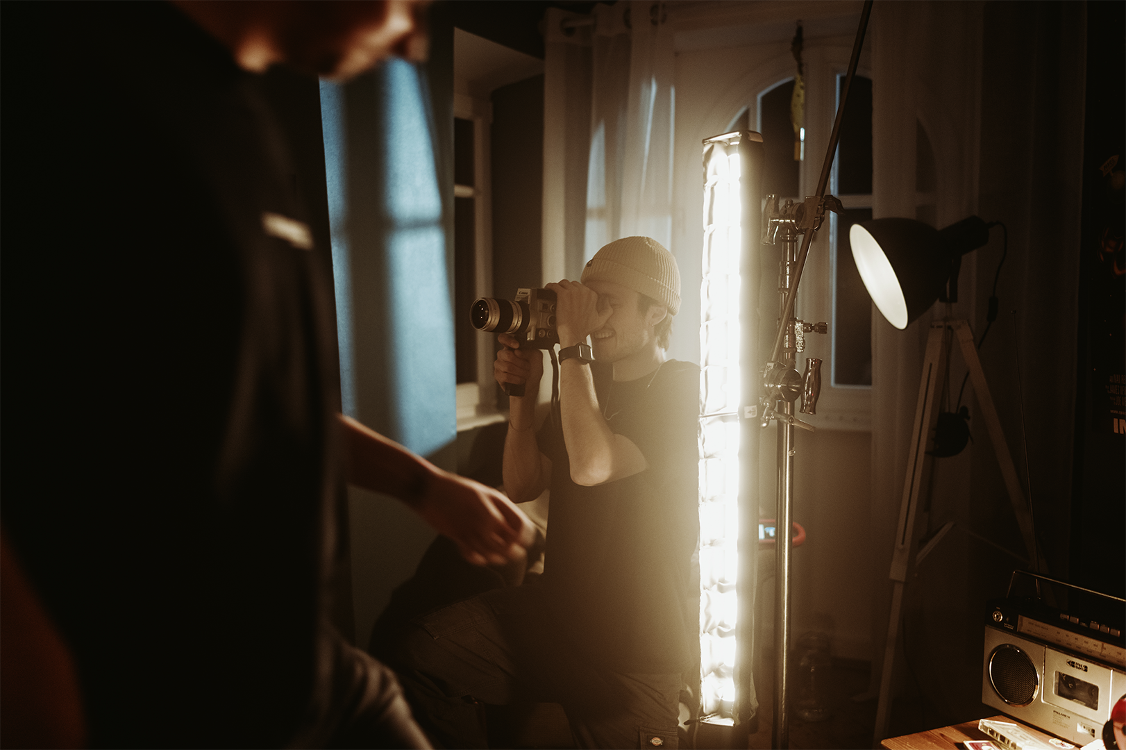 Crew filming with a handheld rig and monitor inside the built set