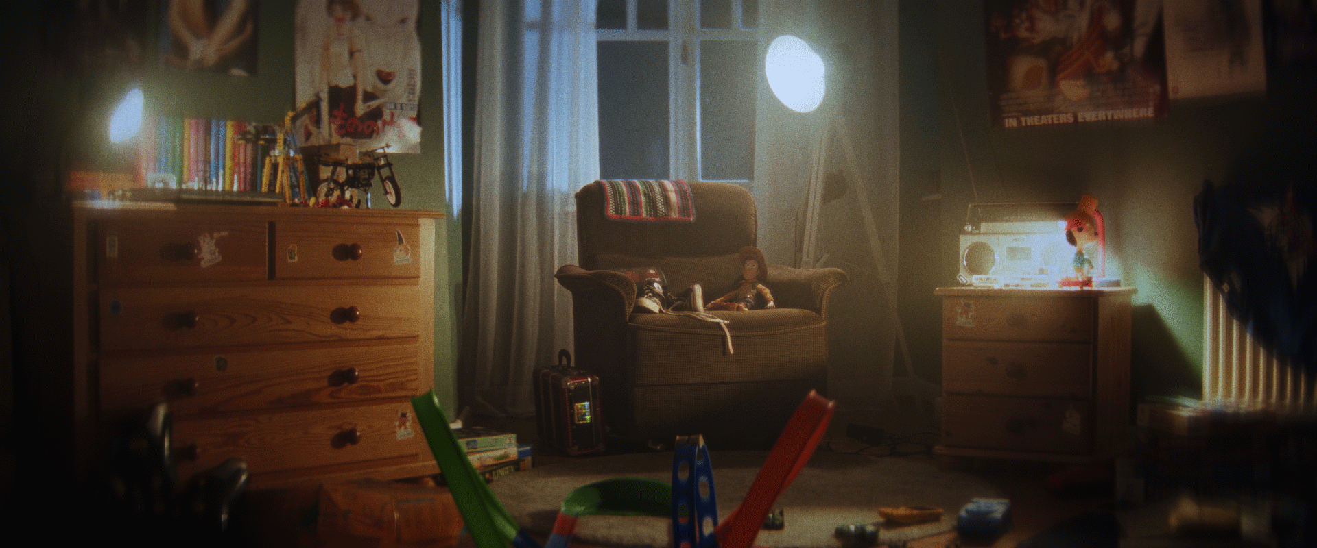 The built set: a lamplit 90s bedroom with an armchair, boombox, and wall of posters