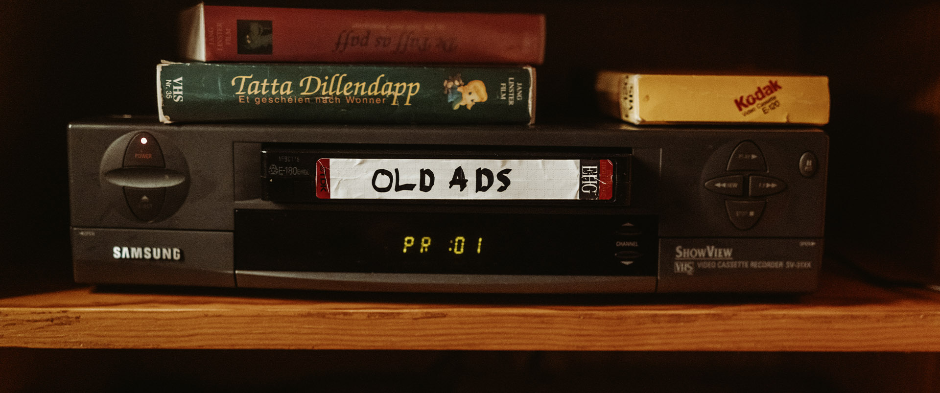 A black VHS tape and box printed with the snug wordmark and made to fit tagline